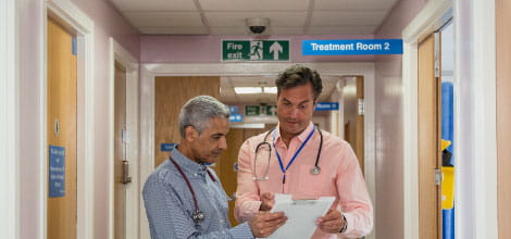 Two GPs discussing work in the GP surgery